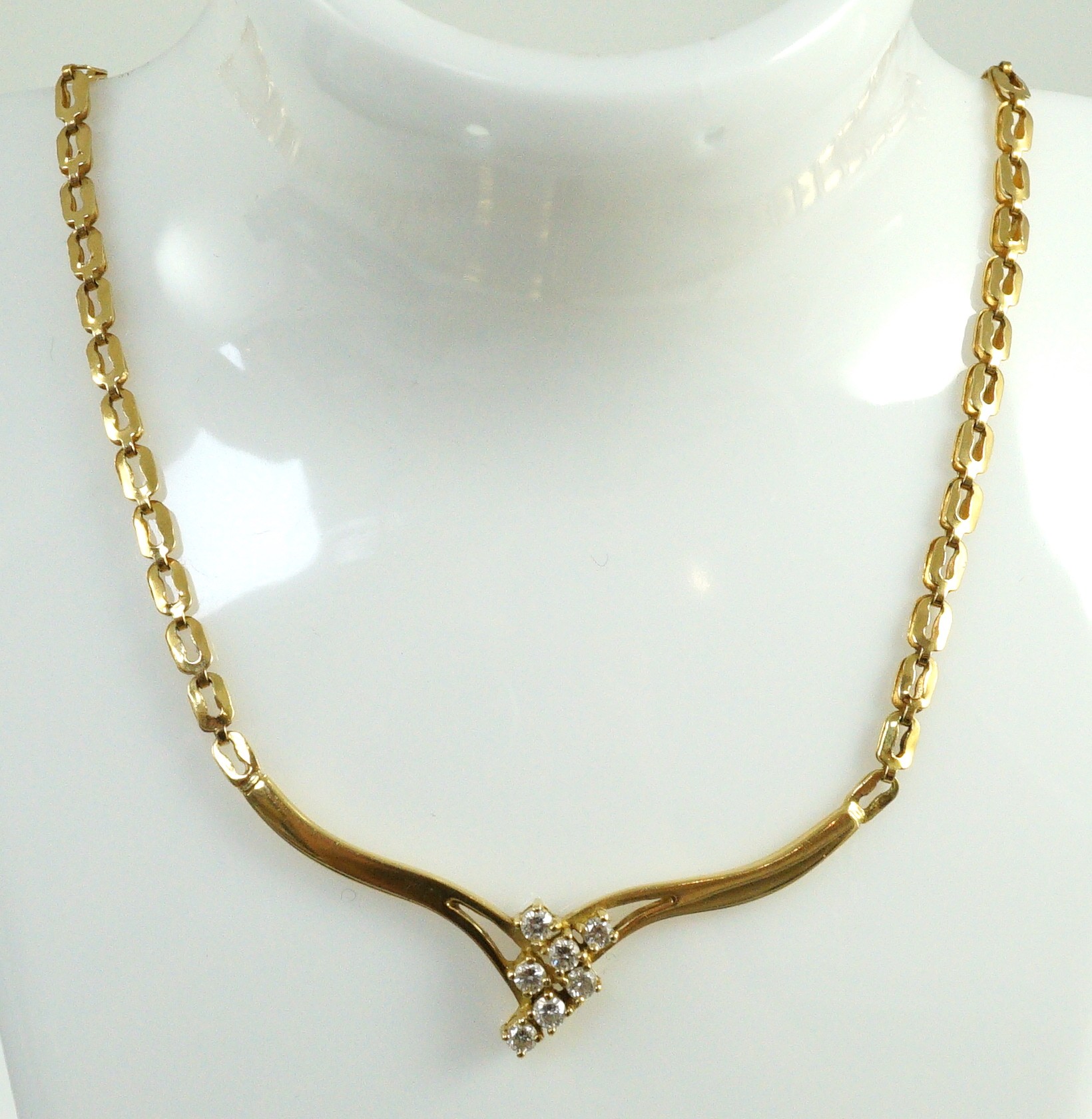 A modern 18k gold and seven stone diamond cluster set necklace